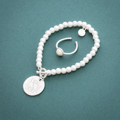 Ring paired with pearl bracelet green background FL