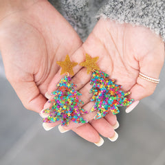 Holding Christmas Tree Earrings in Hands