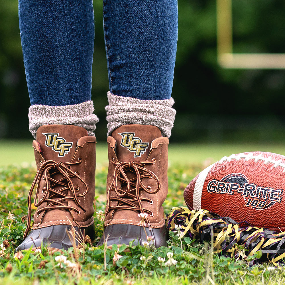 ucf duck boots on football field with poms and football