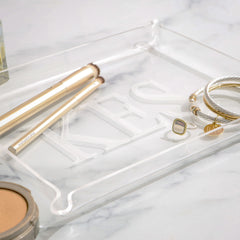 closeup of monogrammed acrylic tray on marble counter
