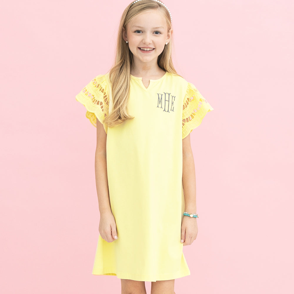 [addie] girl wearing monogrammed girls flutter sleeve dress in soft yellow