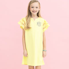 girl wearing monogrammed girls flutter sleeve dress in soft yellow
