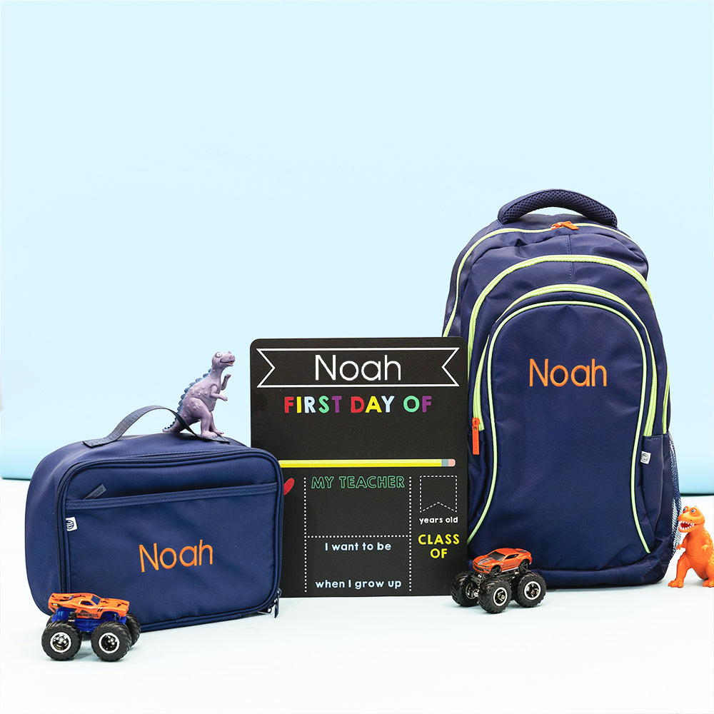 back to school chalkboard with navy bags