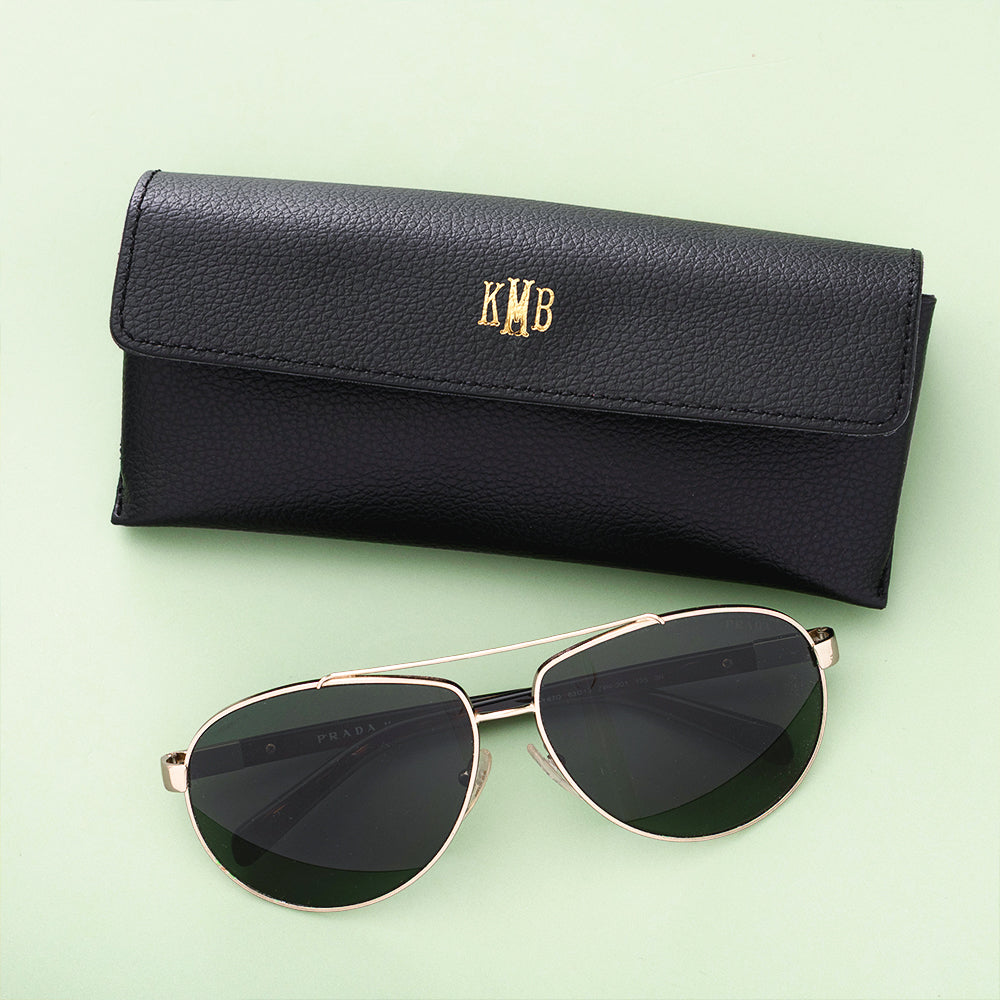 black sunglasses case on green background