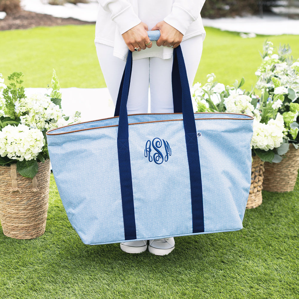 girl carrying personalized extra large tote bag in navy seersucker