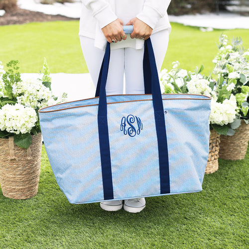 girl carrying personalized extra large tote bag in navy seersucker