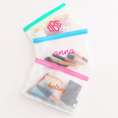 travel accessories in airtight blue green and pink bags