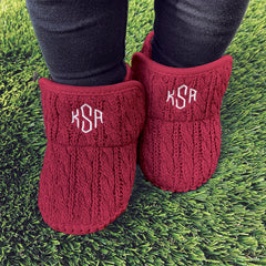 personalized crimson baby booties on grass