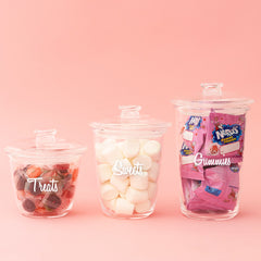 clear containers with sweets, treats, and gummies