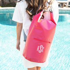 hot pink dry bag on shoulder