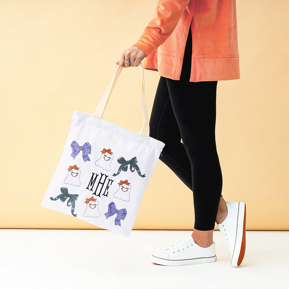 ghost halloween bag in hand orange background