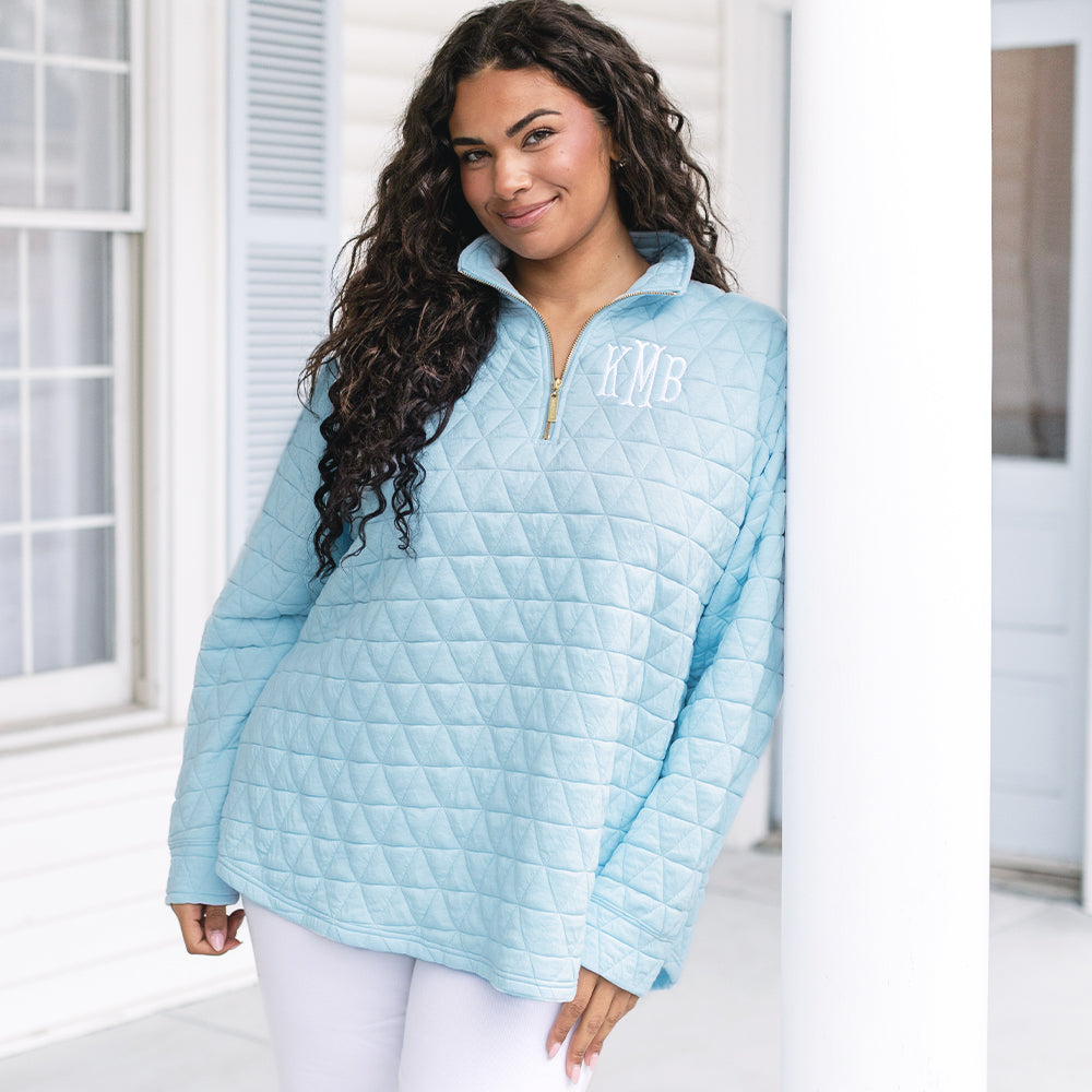 girl wearing personalized quilted quarter zip pullover in ice blue