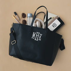 Items spilling out of Carry On Travel Tote in black