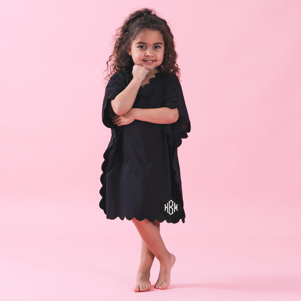 girl in monogrammed bathing suit cover up