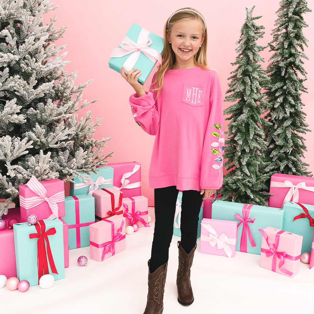 [addie] christmas sweatshirt in hotpink on girl holding a present