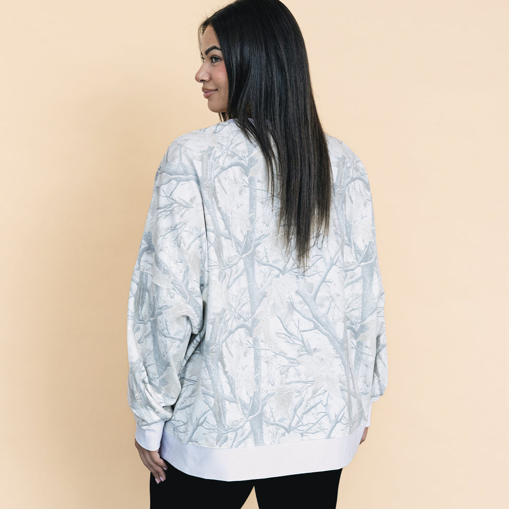 back of girl wearing birch camo oversized monogrammed sweatshirt with leggings