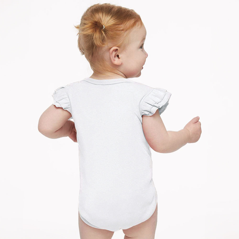 Baby wearing a white bodysuit with ruffled sleeves on a white background