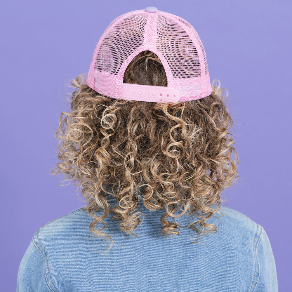 back of girl wearing purple trucker hat 