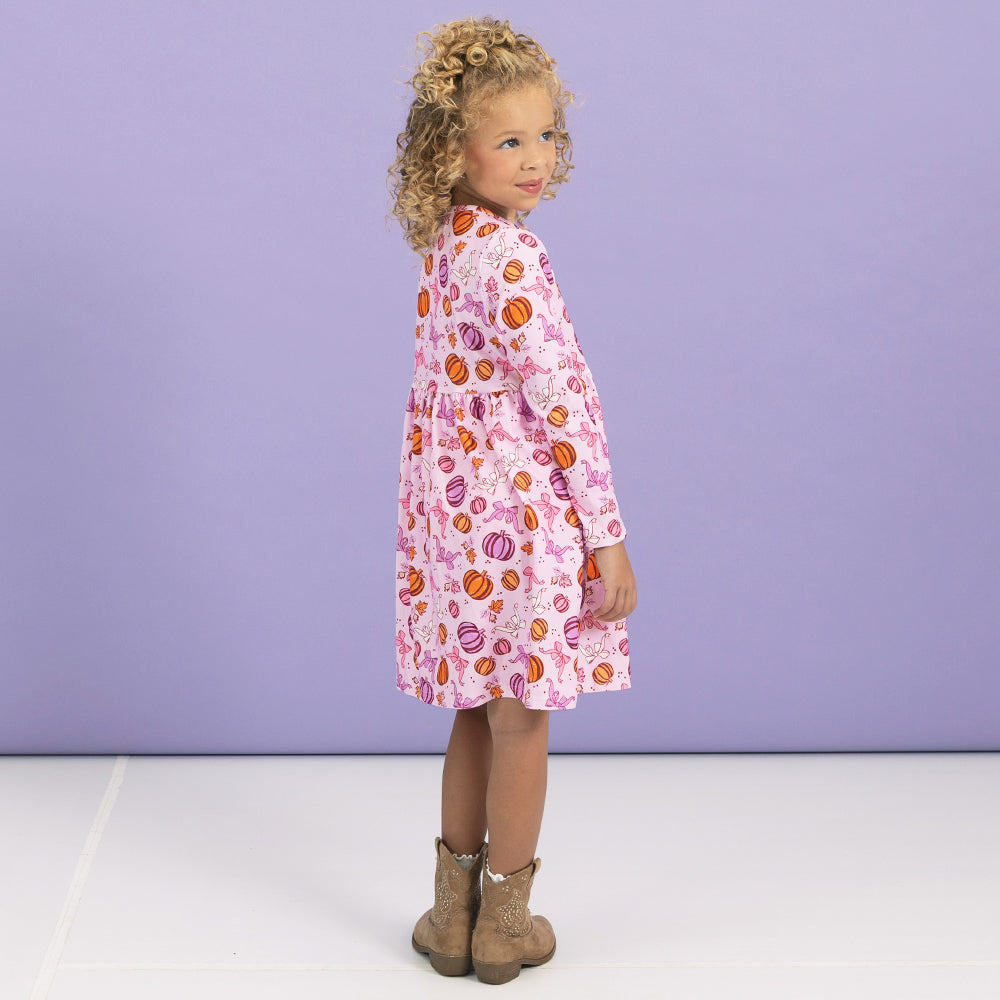 back of girl wearing twirl dress in pretty pumpkins 