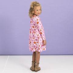 back of girl wearing twirl dress in pretty pumpkins 