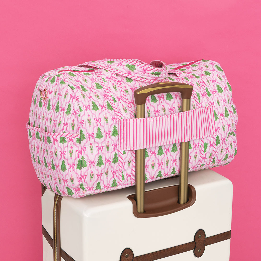 back of monogrammed quilted weekender in christmas lattice trolley loop 