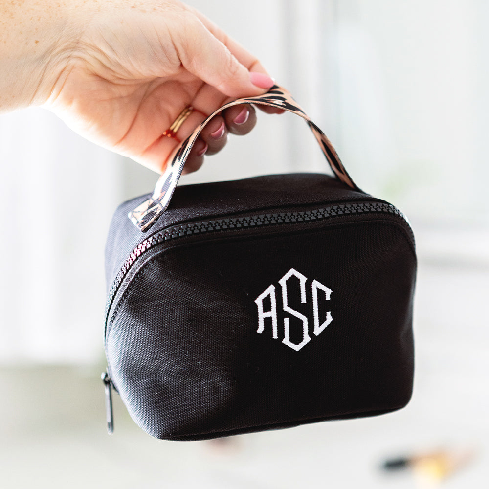 black classic cheetah makeup bag in hand