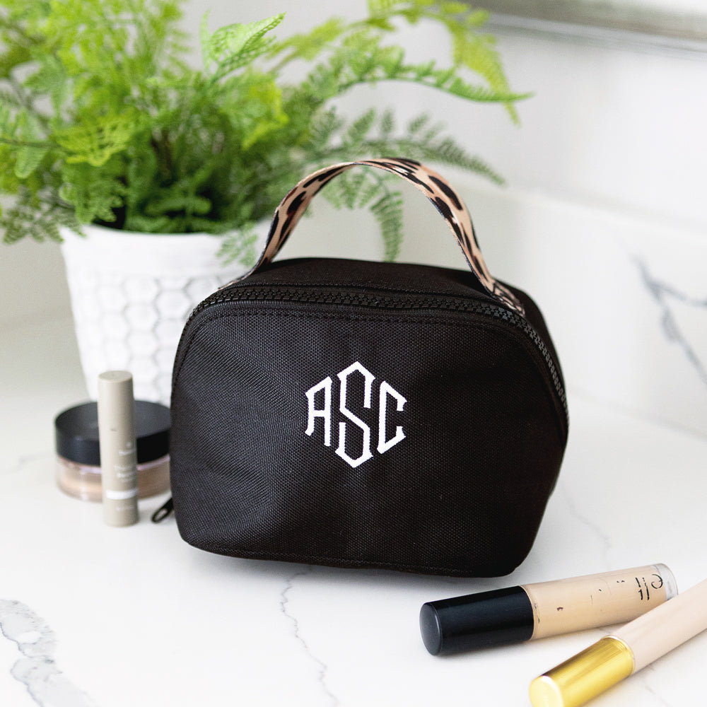 black classic cheetah makeup bag on bathroom counter