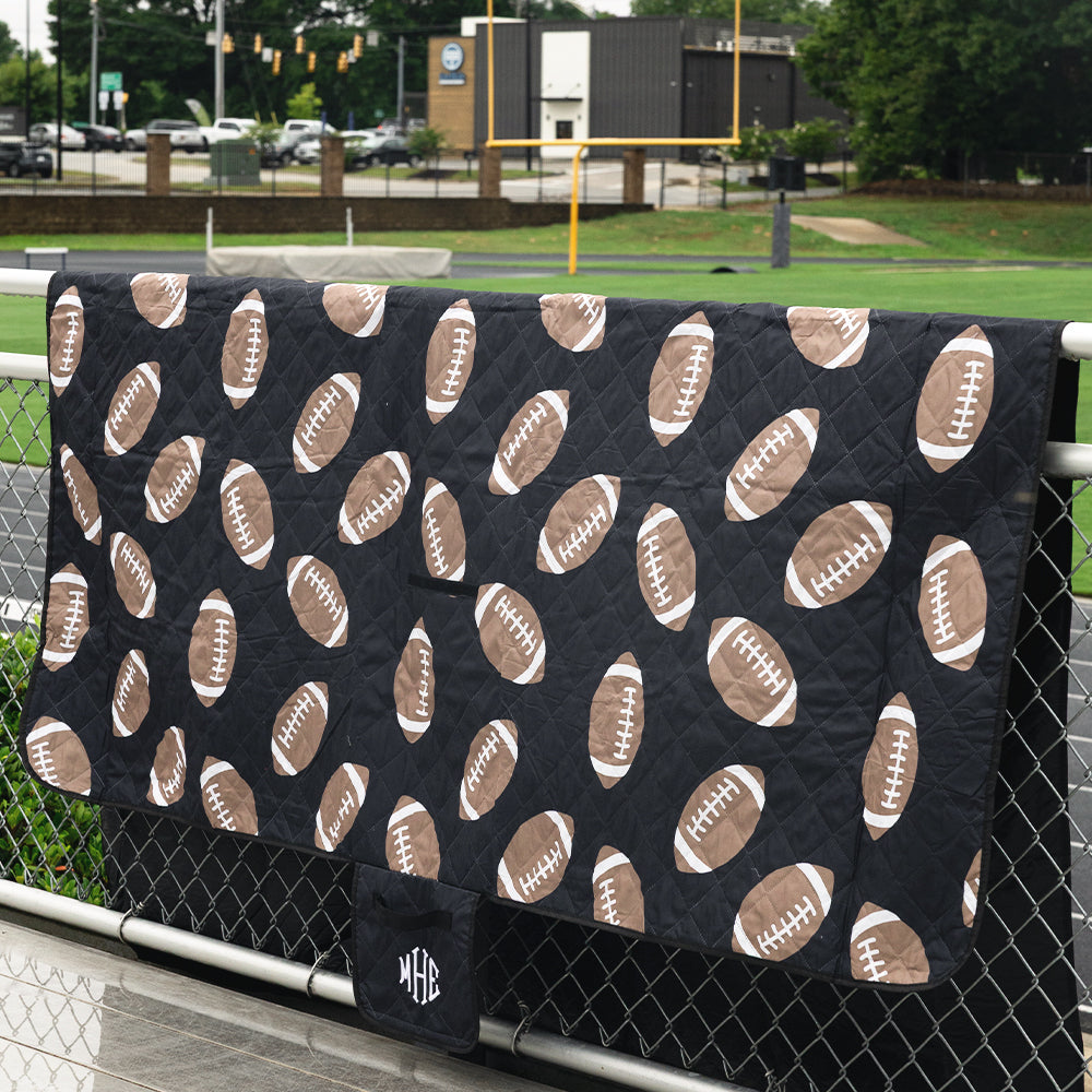 black football picnic blanket on fence