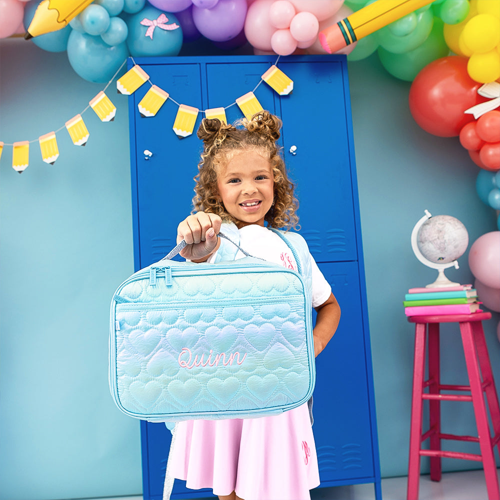 blue quilted hearts lunchbox held up by girl 