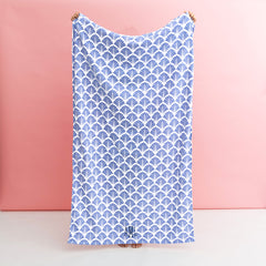 blue shells beach towel being held up