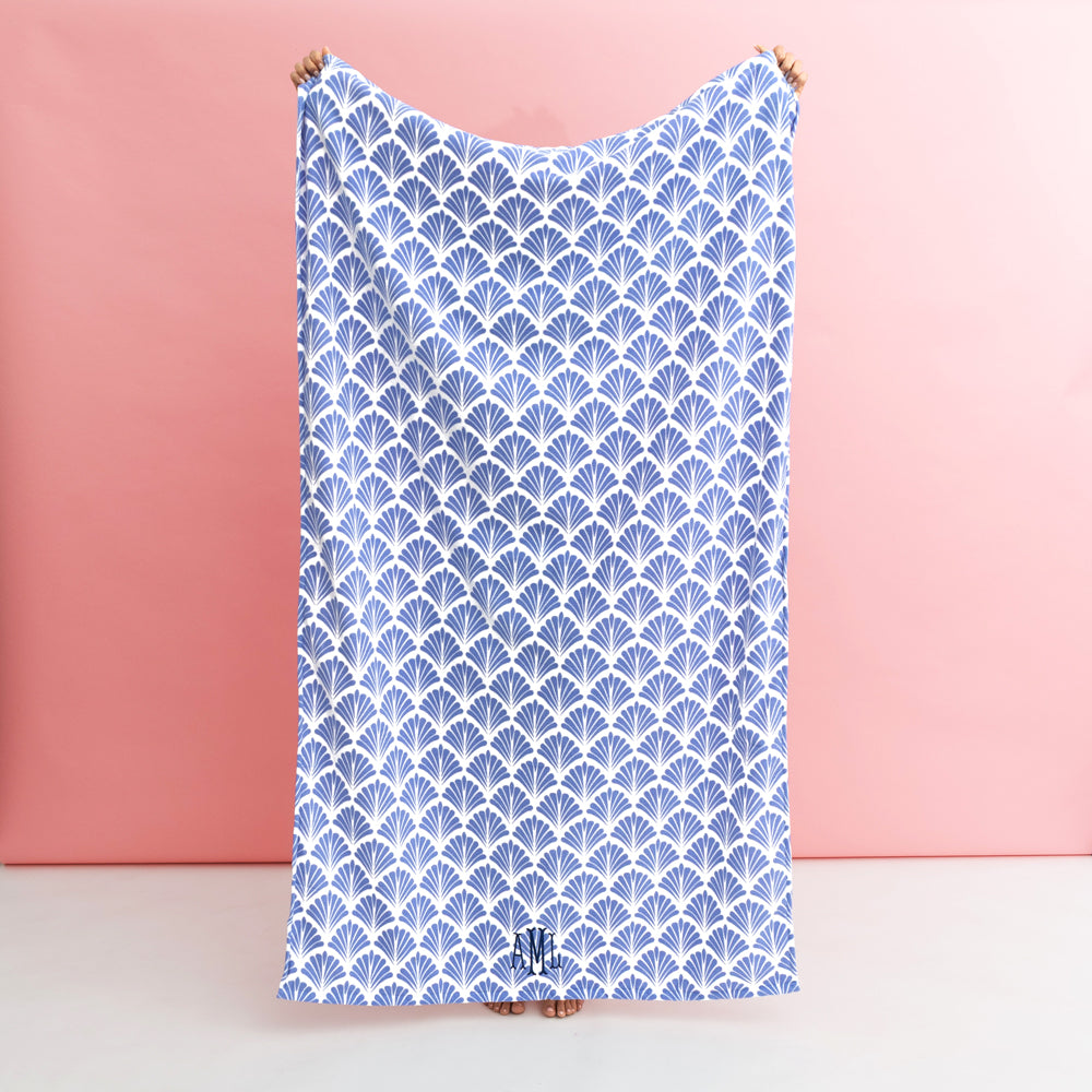 blue shells beach towel being held up
