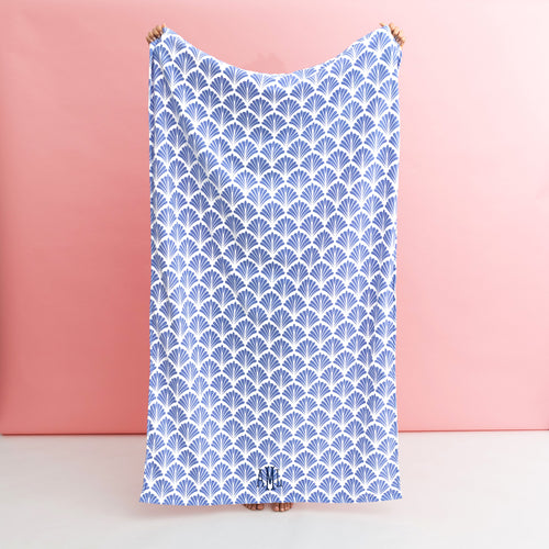 blue shells beach towel being held up