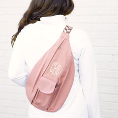 blush sling pack on back