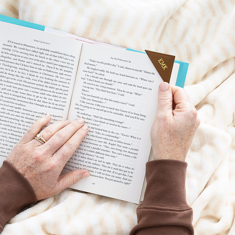 brown corner bookmark while girl reads book