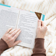 brown corner bookmark while girl reads book