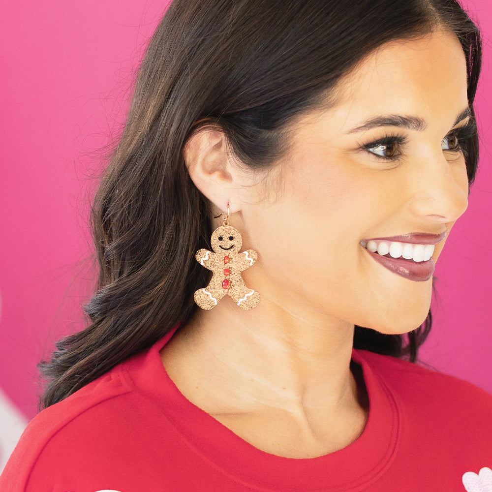 brown gingerbread earrings in ear