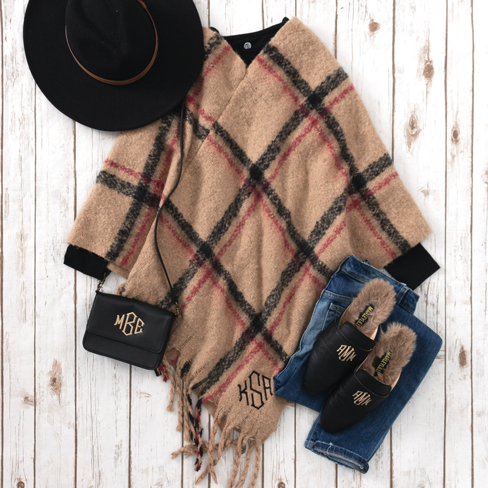 flatlay of camel plaid monogrammed poncho
