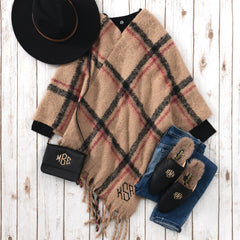 flatlay of camel plaid monogrammed poncho