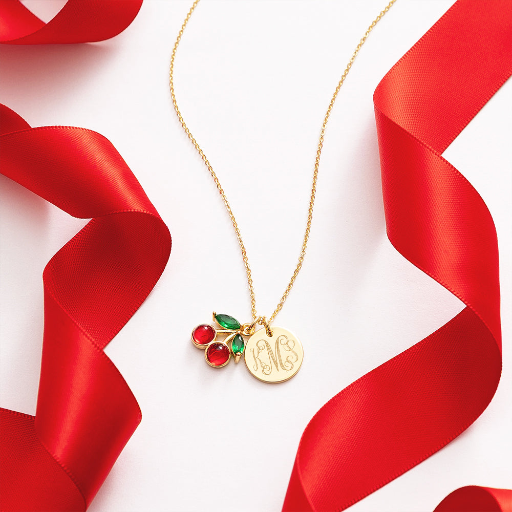 Gold necklace with cherry and monogram charm with red ribbons