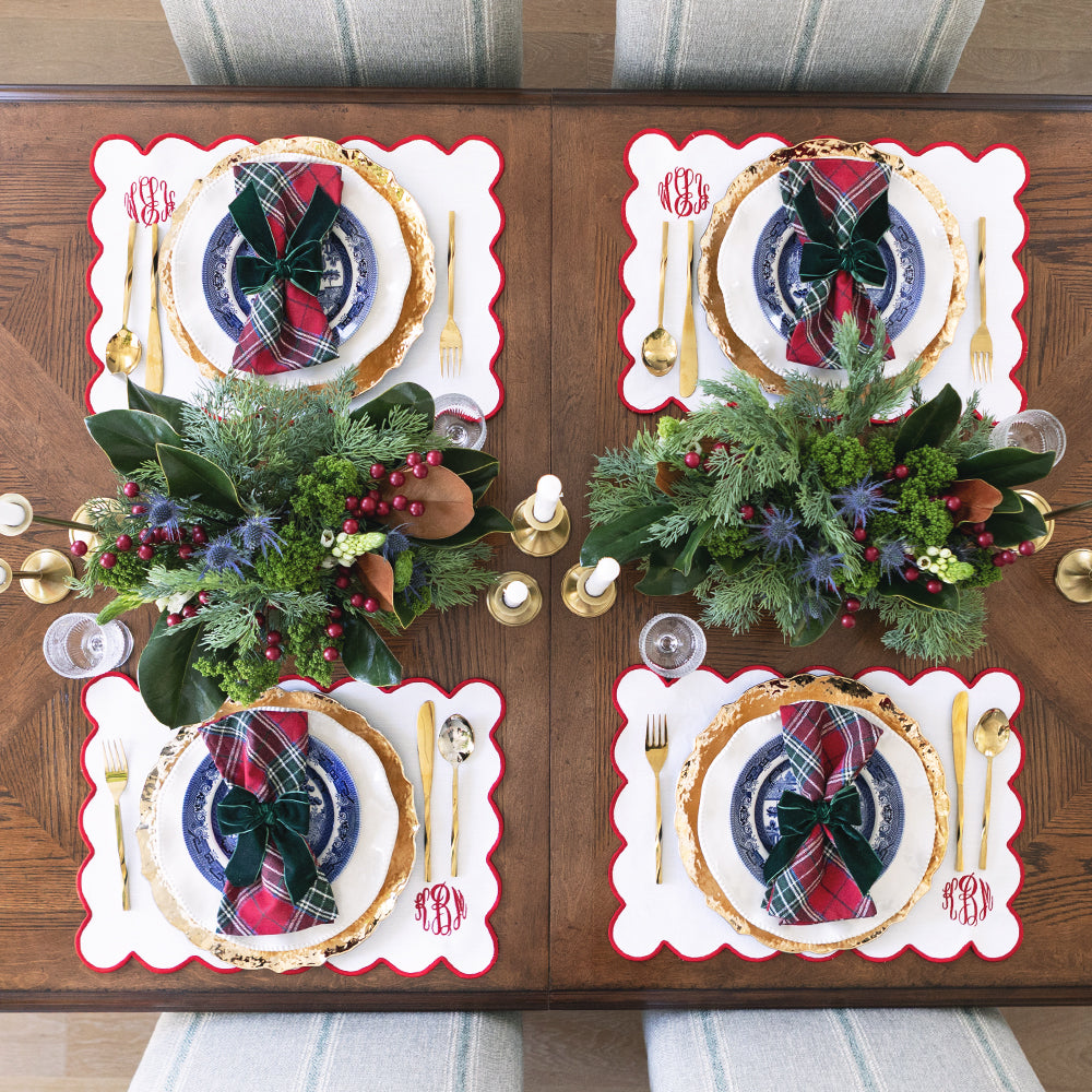 christmas bow napkins holders on tablescape with scalloped napkin and placemat 