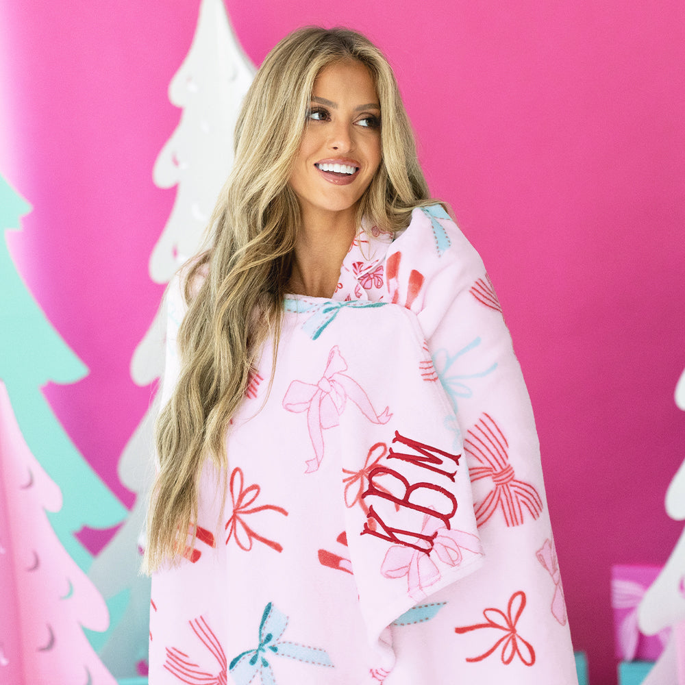 christmas coquette plush blanket wrapped around rachel