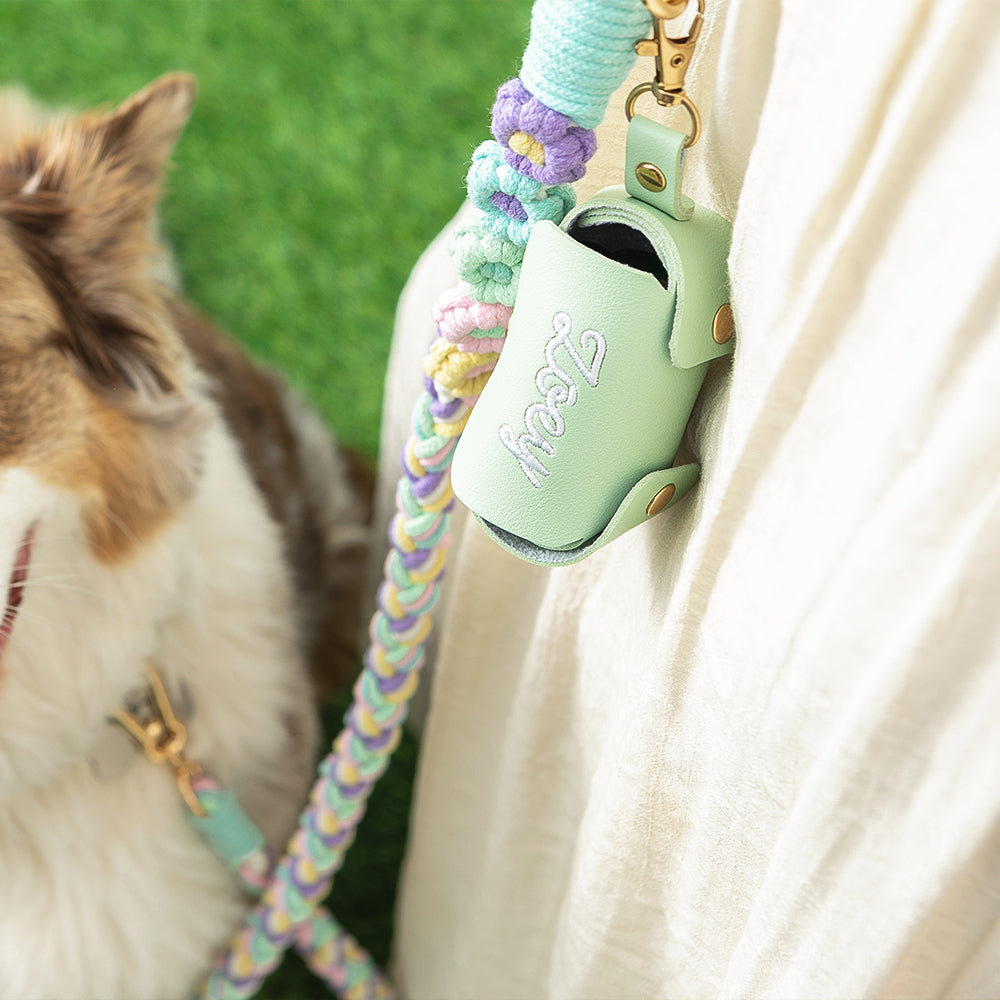 close up of dog and leash with pet waste holder clipped on