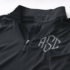 close up of black and grey monogrammed quarter zip pullover 