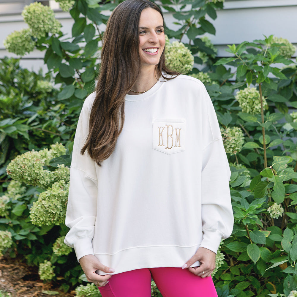 close up of girl wearing ivory monogrammed oversized sweatshirt