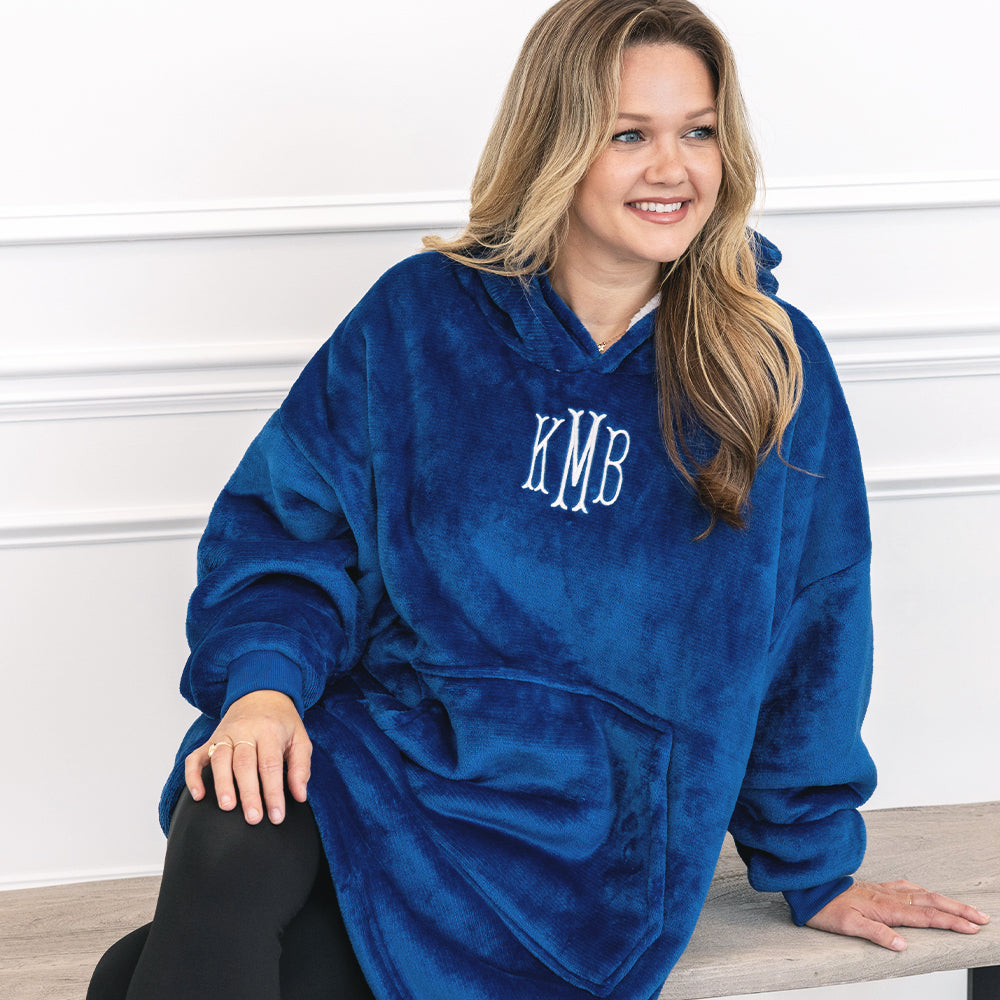 close up of girl wearing monogrammed blanket hoodie in blue 