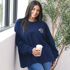 close up of girl wearing navy monogrammed oversized sweatshirt 