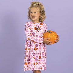 close up of girl wearing pretty pumpkins monogrammed girls twirl dress 
