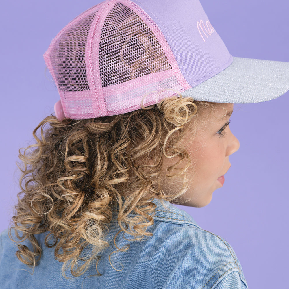 close up of girl wearing purple trunker hat 