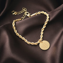 close up of gold monogrammed twisted rope bracelet