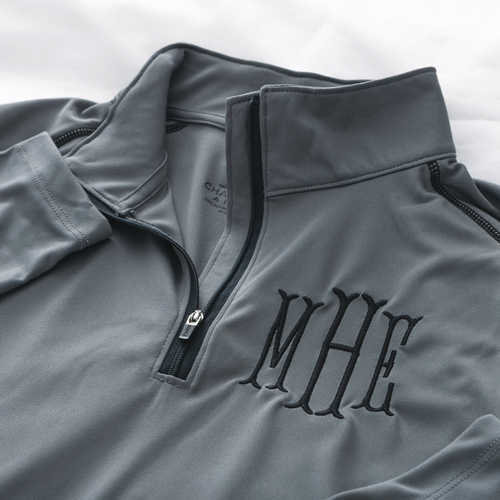 close up of grey monogrammed quarter zip pullover 